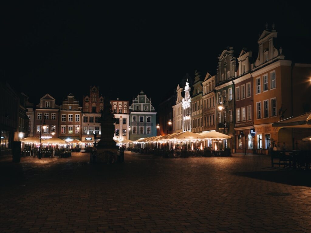 A town square lit up at night with christmas lights